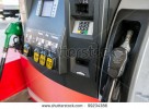 stock-photo-gas-pump-close-up-with-nozzle-in-foreground-99234386